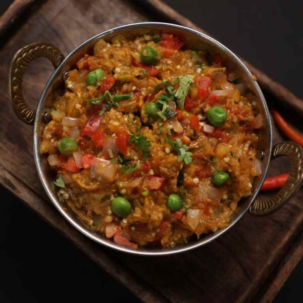 Roasted eggplant with fresh green peas tossed with onion tomato masala.